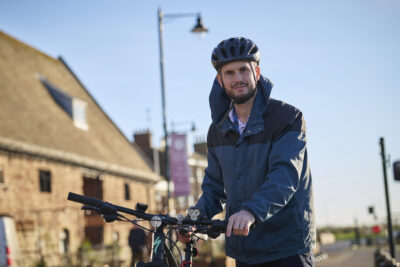man next to his bike